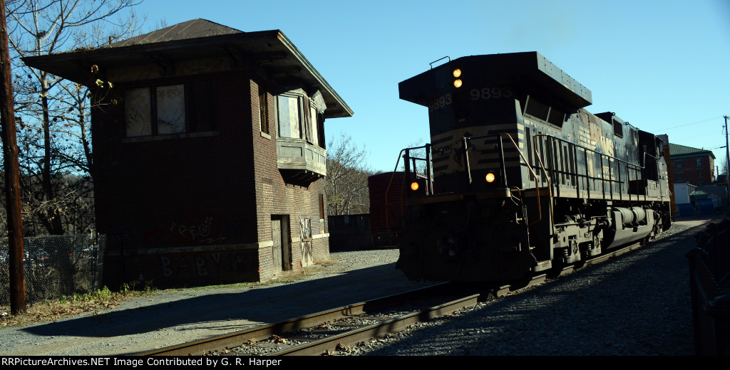 NS 9893, long hood forward, passes by X Tower, which, in days of old, guarded the crossing of the Southern and N&W